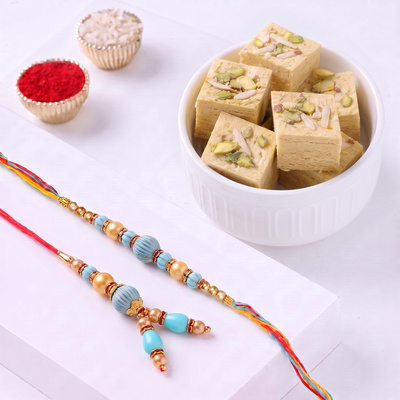 Elegant Blue Stone Rakhi Set and Delightful Soan Papdi Combo