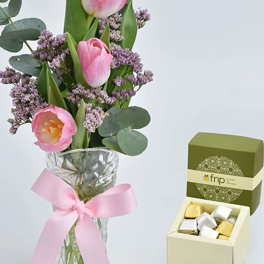 Three Tulips in a Vase With Chocolates