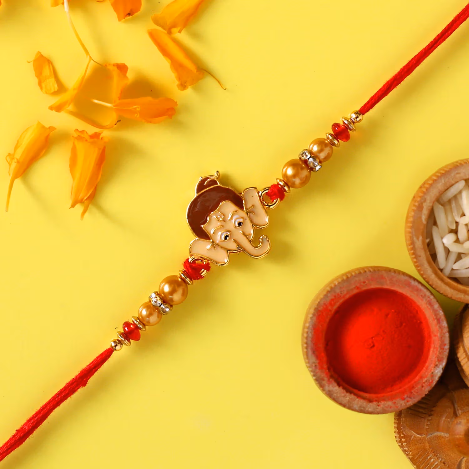 Charming Bal Ganesha Pearl Rakhi for Kids with 250g Haldiram's Soan Papdi Gift Set