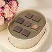 Elegant Crescent Bloom with Gourmet Chocolate Selection