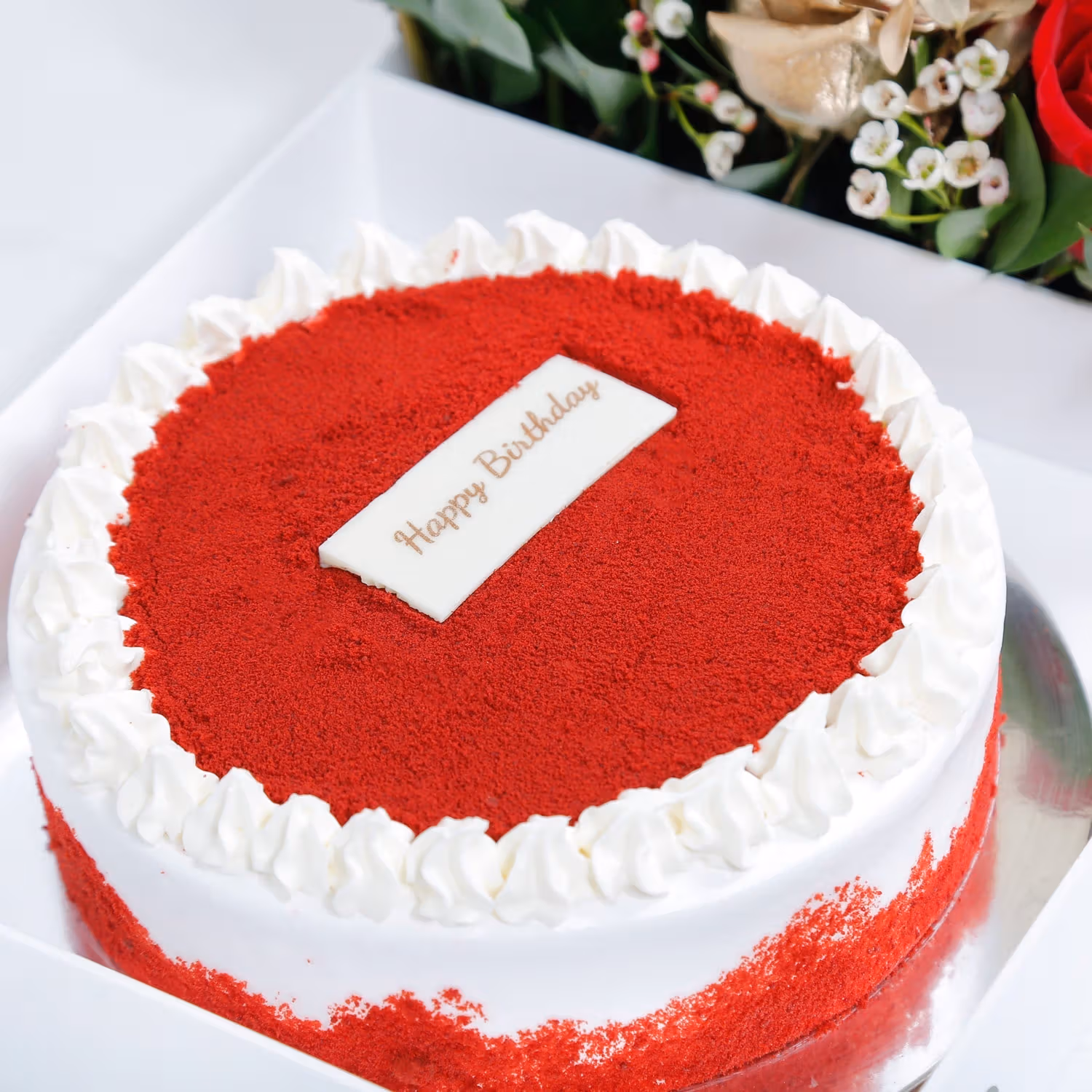 Birthday Bliss: Luxurious Red Velvet Cake with Elegant Floral Arrangement