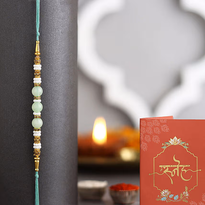 Attractive 6 Stolen Roses Bouquet with Green Pearl Rakhi
