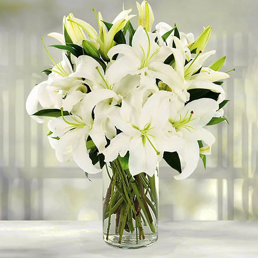 Serene Arranagement Of White Lilies With Ferrero Rocher