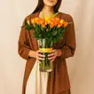 Orange And Yellow Rose Arrangement In A Vase