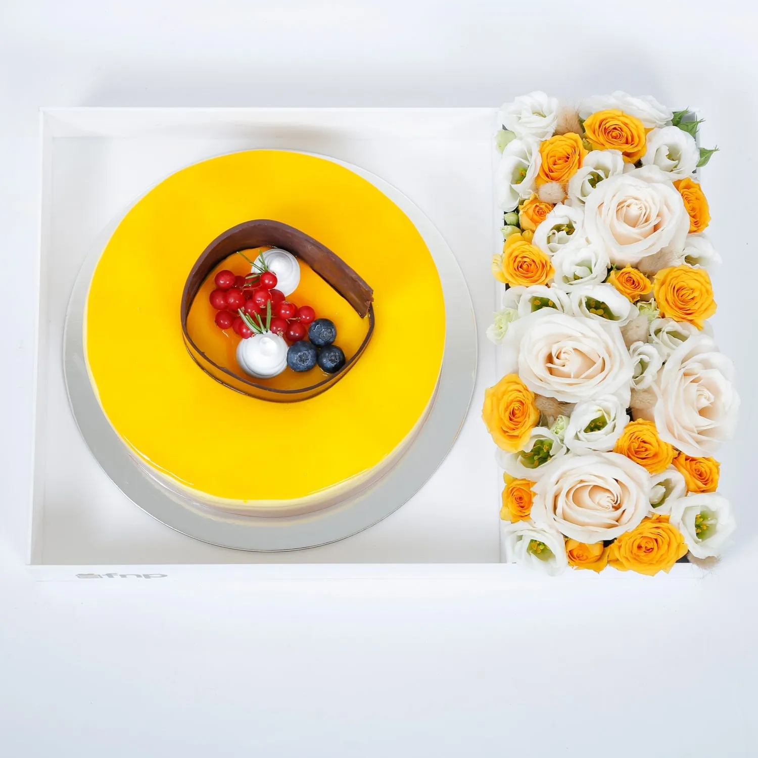 Exquisite Tropical Mango Tango Cake with Elegant Floral Arrangement
