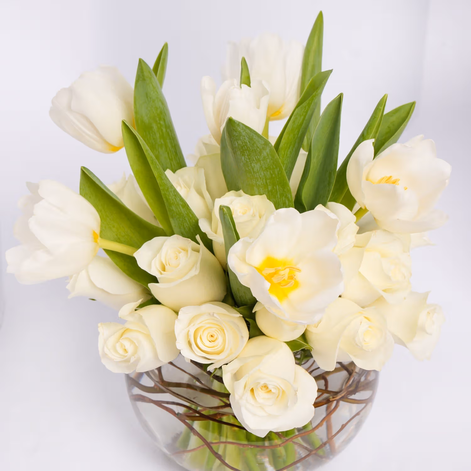 Elegant White Roses and Tulips in a Decorative Glass Vase