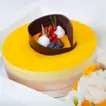 Exquisite Tropical Mango Tango Cake with Elegant Floral Arrangement