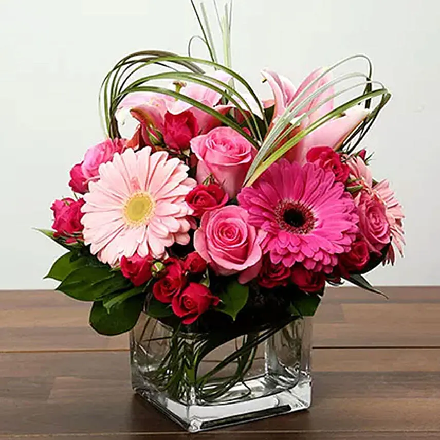 Pink Flowers In Glass Vase With Chocolate Cake