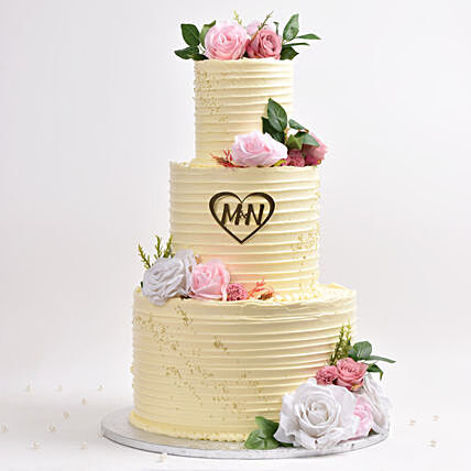 Elegant Three-Tier Wedding Cake with Floral Accents