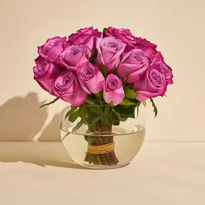 Elegant Arrangement of Purple Roses in a Glass Fish Bowl