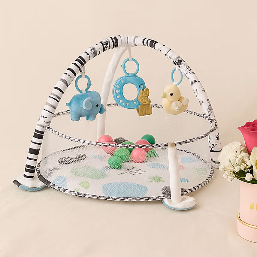 Round Game Mat With Toys and Balls With A Floral Arrangement