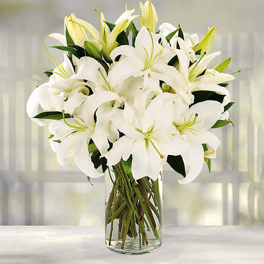 Serene Arranagement Of White Lilies With Chocolate Cake