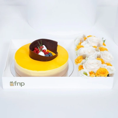 Exquisite Tropical Mango Tango Cake with Elegant Floral Arrangement