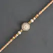 Elegant Rosy American Diamond Rakhi with 1 Kg Ras Malai Delight and Complimentary Roli Chawal