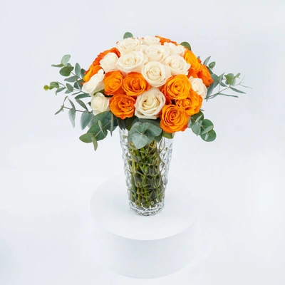 Elegant Orange and Cream Rose Arrangement in Crystal Glass Vase