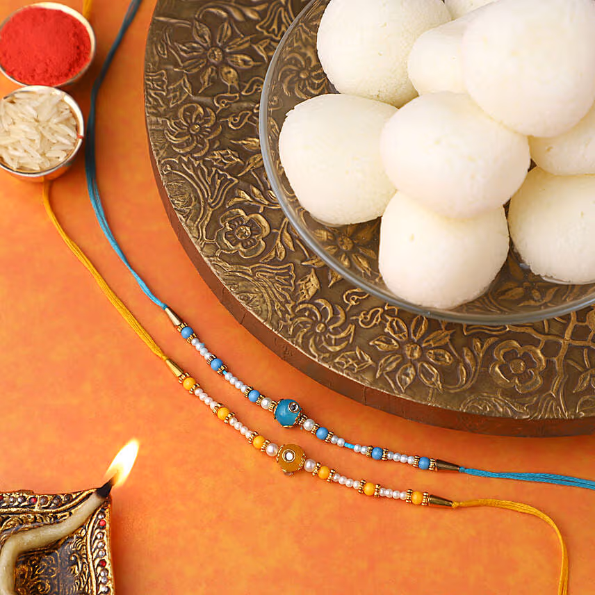 Sneh Vibrant Set Of 2 Pearl Rakhis & Rasgullas