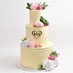 Elegant Three-Tier Wedding Cake with Floral Accents