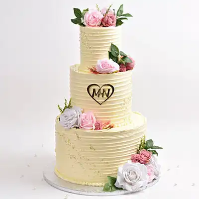 Elegant Three-Tier Wedding Cake with Floral Accents