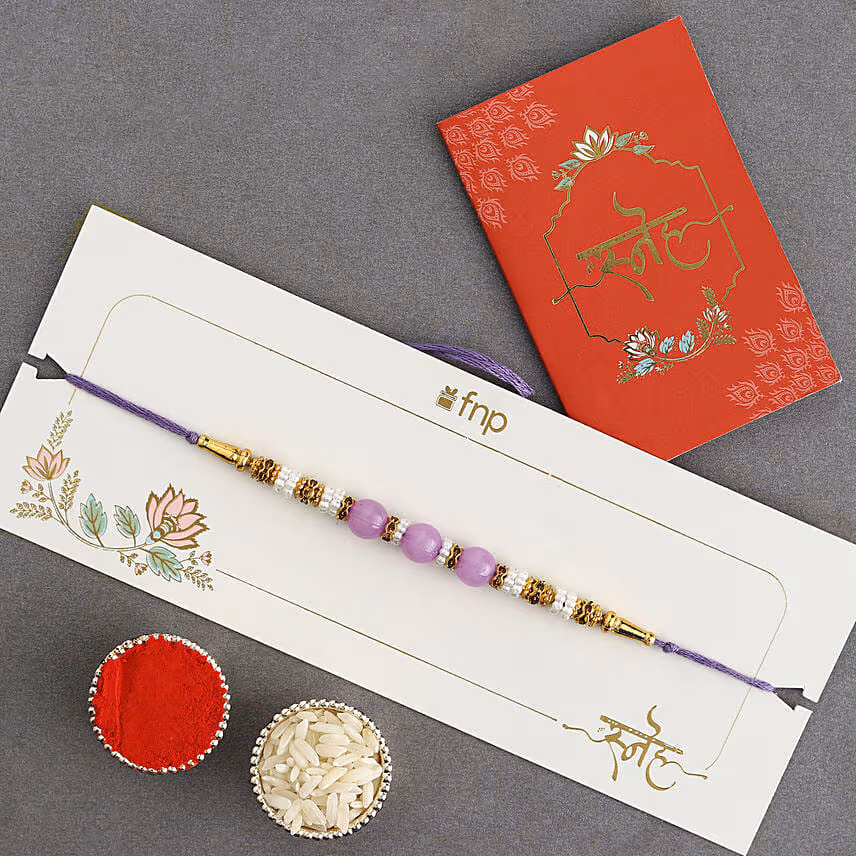Striking Mixed Flowers Round Basket With Purple Pearl Rakhi